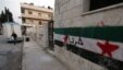 A wall with the Syrian revolutionary flag and Arabic writing which reads "freedom," northern Syria, June 3, 2012.