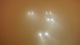 Picture taken on January 14, 2013 shows vehicles running slowly in heavy fog in Hefei, central China's Anhui province. 