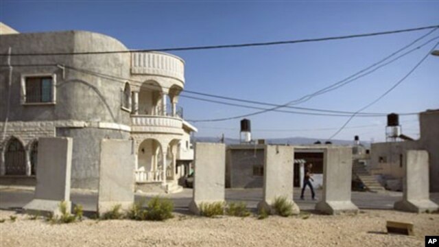 A resident walks in the village of Ghajar on the border with Lebanon, northern Israel, 17 Nov 2010