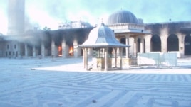 Fire burns after shelling at the Great Mosque of Aleppo, Oct. 13, 2012.