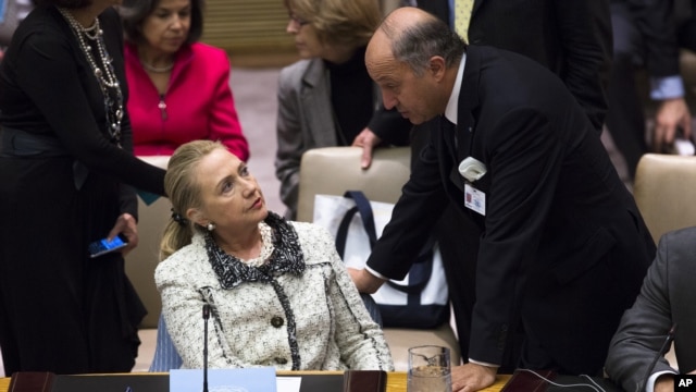 United States Secretary of State Hillary Clinton speaks to French Foreign Minister Laurent Fabius before a meeting of the Security Council during the 67th United Nations General Assembly, at U.N. headquarters in New York, September 26, 2012. 