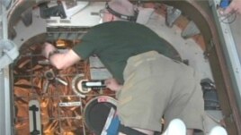 Astronauts on the International Space Station enter the SpaceX Dragon capsule