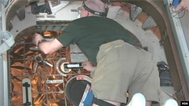 Astronauts on the International Space Station enter the SpaceX Dragon capsule