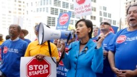 U.S. Congresswoman Judy Chu (D-Calif.) joins U.S. Post Office employees during a protest, April 24, 2014, in downtown Los Angeles.