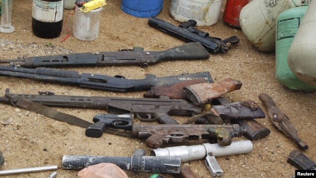 Confiscated weapons are displayed after a military raid on a hideout of suspected Islamist Boko Haram members in Nigeria's northern city of Kano, August 11, 2012.