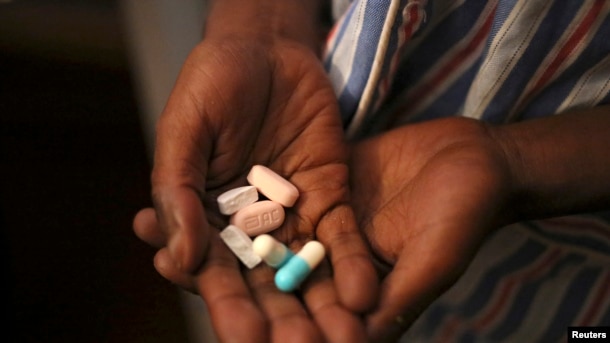 FILE - Nine-year-old Tumelo shows off antiretroviral (ARV) pills before taking his medication at Nkosi's Haven, south of Johannesburg, South Africa, Nov. 28, 2014. Seven million people in the country are currently living with the HIV virus.