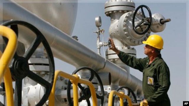 Iranian oil technician Majid Afshari, checks the oil separator facilities in Azadegan oil field, some 480 miles (800 kilometers) southwest of the capital, Tehran, Iran, Tuesday, April 15, 2008.