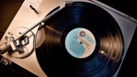 An old vinyl record album on a turntable
