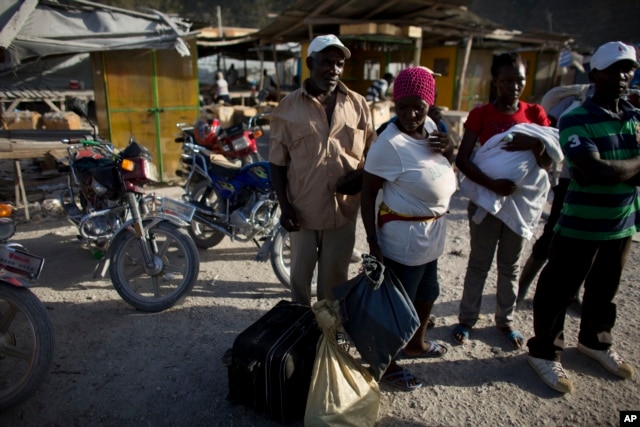Haitian migrants just deported from Dominican Republic stand on the Haitian side of the border unsure what to do next, in Malpasse, Haiti, June 17, 2015.