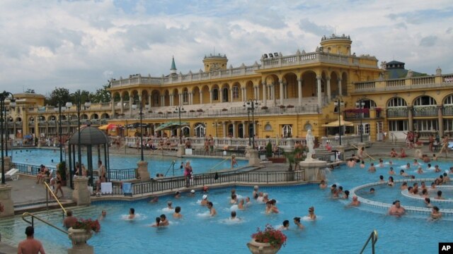 The Neo-Baroque building at Szechenyi Bath and Spa surrounds the outdoor pools, Budapest.