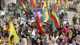 Syrian Kurds demonstrators hold flags and portraits of jailed Kurdistan Workers Party (PKK) leader Abdullah Ocalan during a protest in Derik, Al Hasakah, Syria, November 1, 2012.