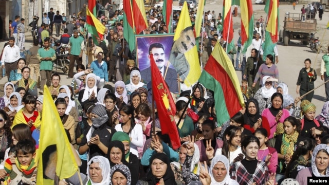 Syrian Kurds demonstrators hold flags and portraits of jailed Kurdistan Workers Party (PKK) leader Abdullah Ocalan during a protest in Derik, Al Hasakah, Syria, November 1, 2012.