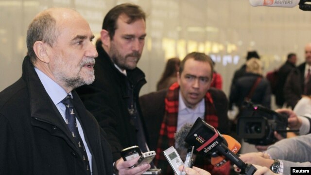 Herman Nackaerts (L) , head of a delegation of the International Atomic Energy Agency (IAEA), speaks to journalists at the airport in Vienna after arriving from Iran, December 14, 2012.