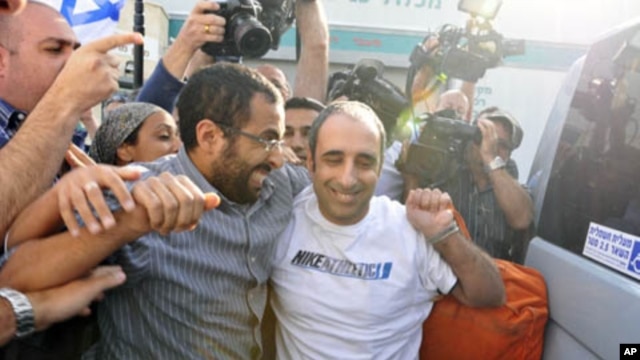 Hagai Amir (R), the brother of the man who assassinated the late Israeli Prime Minister Yitzhak Rabin, rejoices after his release from Ayalon prison, south of Tel Aviv May 4, 2012.