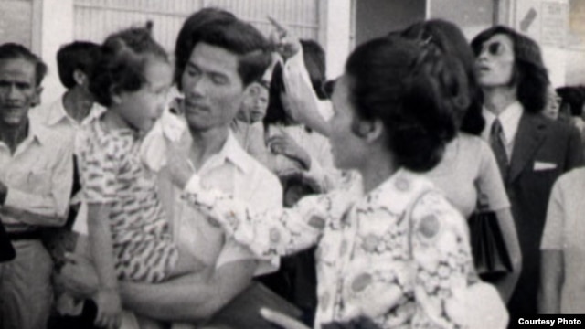 Neou Sarem says goodbye to her husband, Nuon Sari, and her 3-year old daugther, Nuon Sari Sakhura, at Pochentong Airport, 1974.