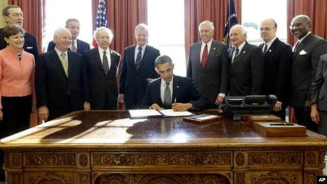 President Obama signs the Russia and Moldova Jackson-Vanik Repeal and Sergei Magnitsky Rule of Law Accountability Act Oval Office, Washington, Dec. 14, 2012.