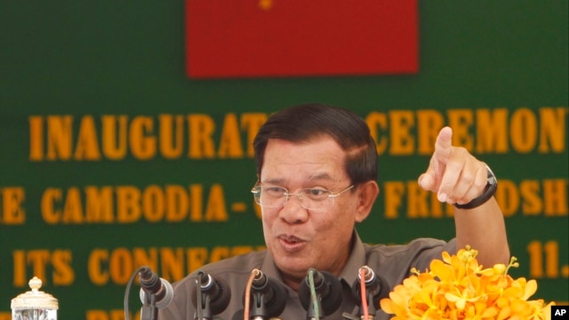 Cambodia's Prime Minister Hun Sen gestures as he delivers a speech during his presiding over an inauguration ceremony for the official use of a friendship bridge between Cambodia and China at Takhmau, Kandal provincial town south of Phnom Penh, Cambodia, Monday, Aug. 3, 2015.