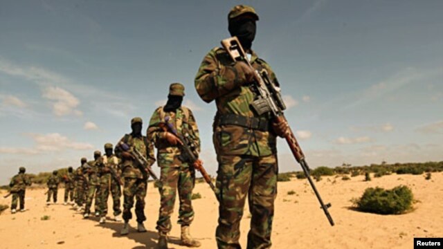 Members of Somalia's al-Shabaab militant group parade during a demonstration to announce integration with al Qaida, in Elasha, south of the capital Mogadishu, February 13, 2012.