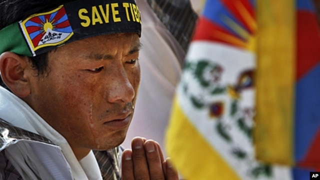 Tears roll down the cheeks of a Tibetan exile as he listens to a speaker during a protest outside the Chinese Embassy on the first day of Tibetan New Year, in New Delhi, India,  February 22, 2012.