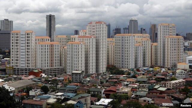 Rows of condominium buildings are seen behind a middle-class residential district in Mandaluyong, Metro Manila, July 4, 2012.