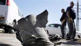 Israeli bomb technicians inspect the remains of a rocket fired from the Gaza Strip which landed near the southern city of Ashkelon on February 26, 2013.