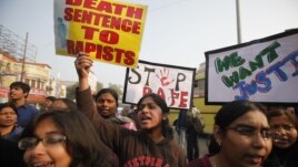 ndian students protesting against the brutal gang-rape of a woman on a  bus last week in New Delhi, hold placards during a protest in Allahabad, India, Dec. 26, 2012
