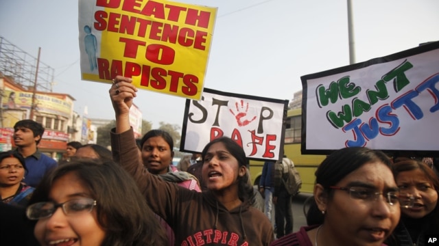 ndian students protesting against the brutal gang-rape of a woman on a  bus last week in New Delhi, hold placards during a protest in Allahabad, India, Dec. 26, 2012