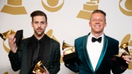 Hip hop artists Macklemore (R) and Ryan Lewis pose backstage with their awards for Best New Artist, Best Rap Performance for "Thrift Shop", Best Rap Song for "Thrift Shop" and Best Rap Album for "The Heist", Jan. 26, 2014.