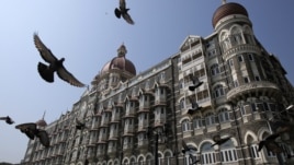Pigeons fly outside the Taj Mahal Hotel, which was one of the targets of the attacks in Mumbai, Nov. 21, 2012.