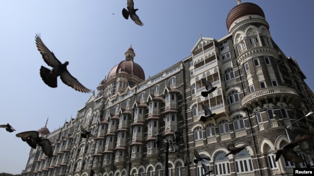 Pigeons fly outside the Taj Mahal Hotel, which was one of the targets of the attacks in Mumbai, Nov. 21, 2012.