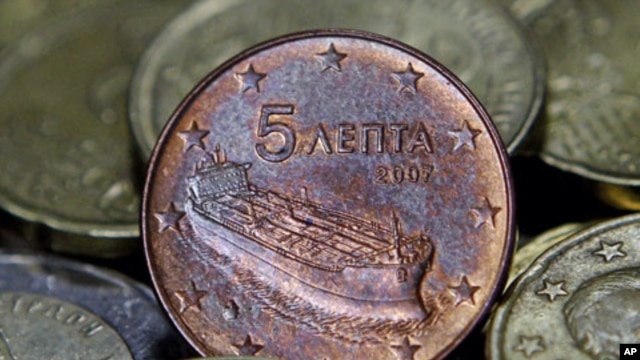 A Greek five-cent euro coin depicting a tanker is seen amongst other coins in Athens, Greece, February 15, 2012.