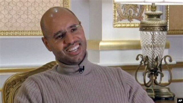 Seif al-Islam Gadhafi, son of Libyan Leader Moammar Gadhafi, smiles during a TV interview in Tripoli in this image taken from TV, March 16, 2011
