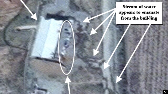 This April 9, 2012 photo provided by the Institute for Science and International Security, ISIS shows suspected cleanup activities at a building alleged to contain a high explosive chamber used for nuclear weapon related tests in the Parchin military comp