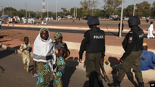 Nigerian police patrol as people attend prayers marking the muslim festival of Eid al-Adha in the capital Abuja, November 6, 2011.