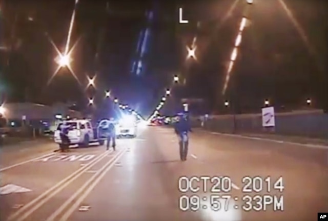 In this Oct. 20, 2014 frame from dash-cam video provided by the Chicago Police Department, Laquan McDonald walks down the street moments before being shot by police officer Jason Van Dyke.