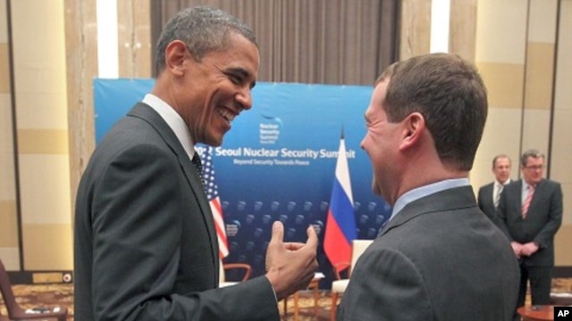U.S. President Barack Obama, left, and Russian President Dmitry Medvedev talk and smile at each other following the conclusion of their bilateral meeting at the Nuclear Security Summit in Seoul, South Korea,  March, 26, 2012. 