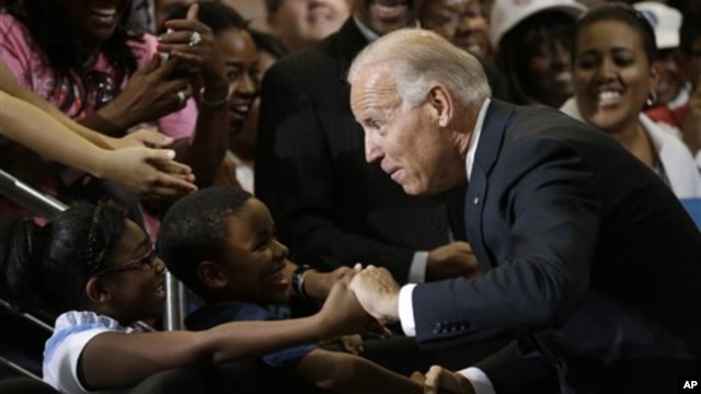 Vice President Joe Biden greets Lawrence Smith, 8, and Madison King, 9, both of Van Buren Township, Michigan, during a campaign stop at Renaissance High School in Detroit, Michigan, August 22, 2012.