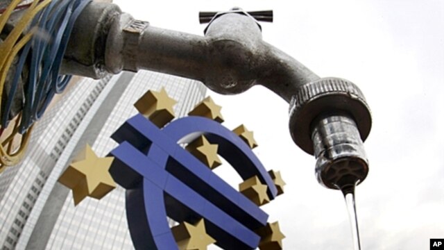 Water runs from a tap in front of the Euro sculpture at the European Central Bank in Frankfurt, Germany, December 1, 2011.