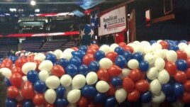 Red, white and blue balloons bundled up before being lifted to the ceiling of the Tampa Bay Times Forum for the traditional "balloon drop" on the final convention night.