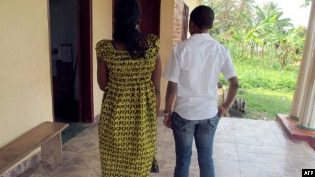 FILE - Esther, 29, and Martine, 26, from Yaounde, on trial in Cameroon accused of homosexuality, March 15, 2012