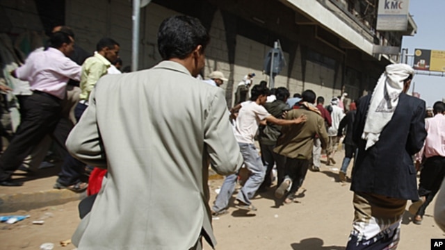 Anti-government protesters flee after security forces opened fire to disperse them in Sana'a,  September 19, 2011.