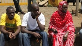 Relatives wait for the bodies of slain police officers to arrive at Wilson Airport in Nairobi, Nov. 13, 2012. Suspected cattle thieves hid on a high hill and ambushed and killed at least 34 police officers pursuing them over the weekend in northwestern Kenya.