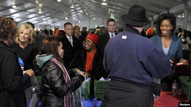 First Lady Michelle Obama (R) and Jill Biden (L), wife of Vice President Joe Biden, are seen participating in volunteer activities on a previous National Day of Service (file photo).