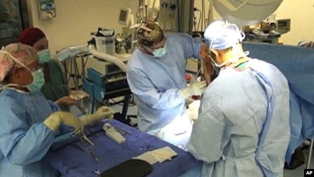 Physicians work at the NATO hospital at Kandahar Airfield, Afghanistan