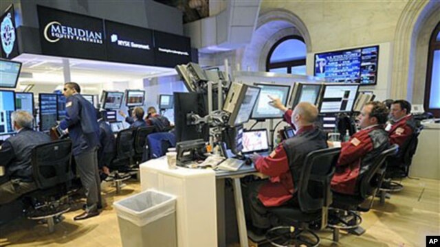 Traders at Meridian Equity Partners work on the floor of the New York Stock Exchange in New York, September 6, 2011.