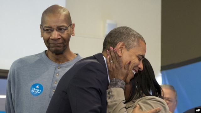 President Barack Obama is embraced by a volunteer as he visits a campaign office the morning of the 2012 election in Chicago, November 6, 2012.