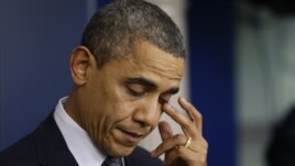 President Barack Obama wipes his eye as he speaks about the elementary school shooting in Newtown, Connecticut, Friday, Dec. 14, 2012, in the briefing room of the White House.