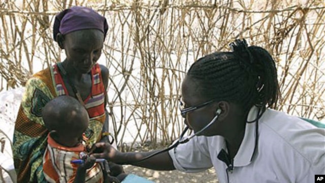 A Turkana woman holds a young child as both are examined for malnutrition by a World Vision nurse at a feeding and treatment center in Lokori, Kenya, July 28, 2011