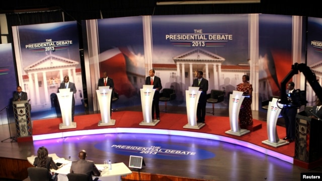 The eight Kenyan presidential aspirants Mohammed Dida, James Ole Kiyiapi, Uhuru Kenyatta, Peter Kenneth, Musalia Mudavadi, Martha Karua, Kenyan Prime Minister Raila Odinga and Paul Muite (L-R) face off in a presidential debate in Nairobi, February 11, 201