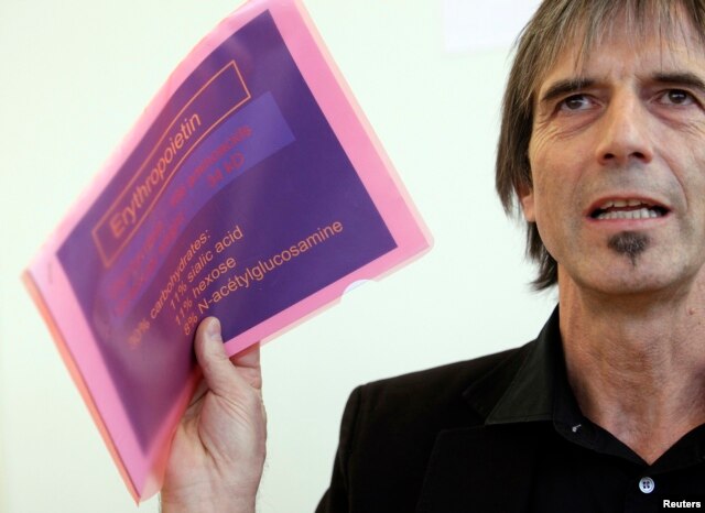 Director of the Swiss anti-doping laboratory Martial Saugy holds papers of a presentation during a news conference in Lausanne, January 11, 2013, as he reacts to declarations of Travis Tygart, Head of USADA that Saugy met with cyclist Lance Armstrong and gave him the key to EPO testing.